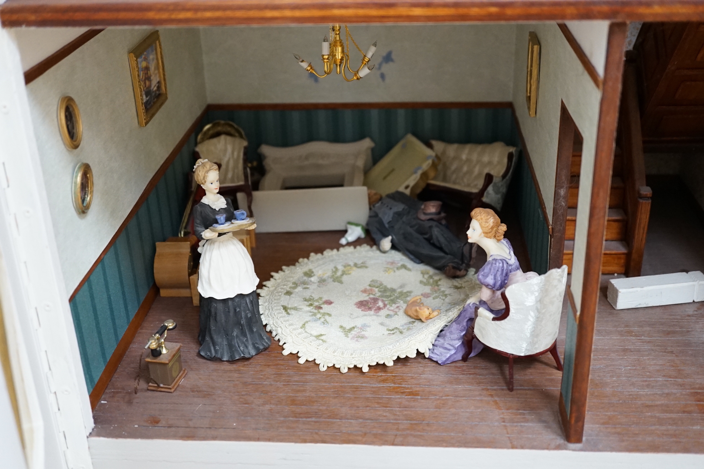 A modern Georgian style dolls house, with two front opening doors, containing six rooms with furnishings, figures, and electric lighting, together with a dolls shop, containing two rooms, furnishings, and accessories, et